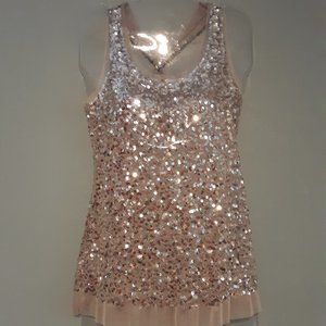 Sheer and silver sequin tank top with gemstone embellishment at neck line.